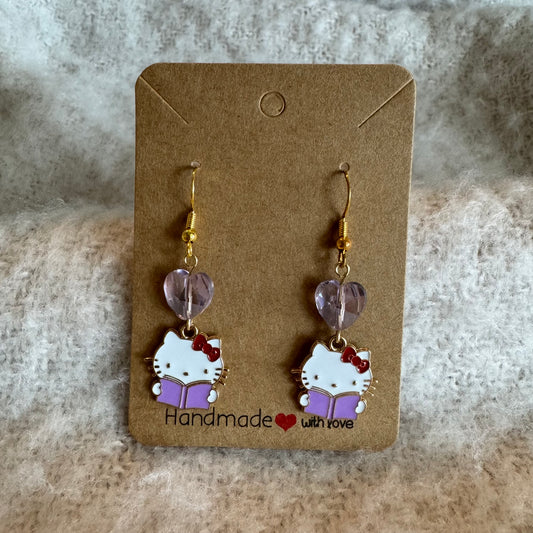 Purple Hello Kitty reading a purple book with heart bead| gold dangle earrings| nickel free