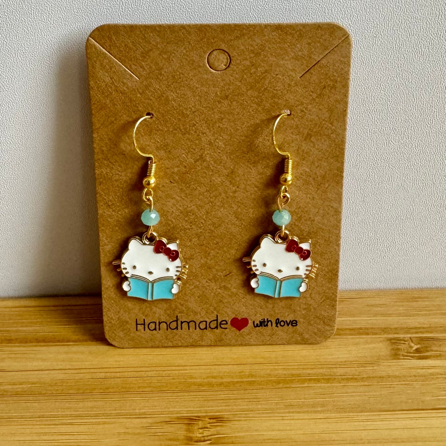Hello Kitty Reading Gold Dangle Light Blue Gemstone Spring Kawaii Cute Earrings perfect for her